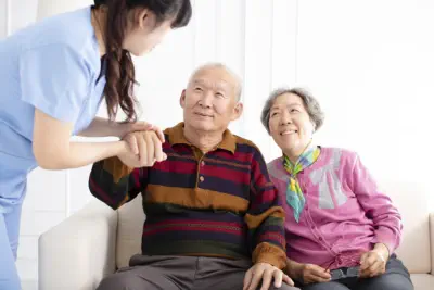 Caregiver helping elderly couple