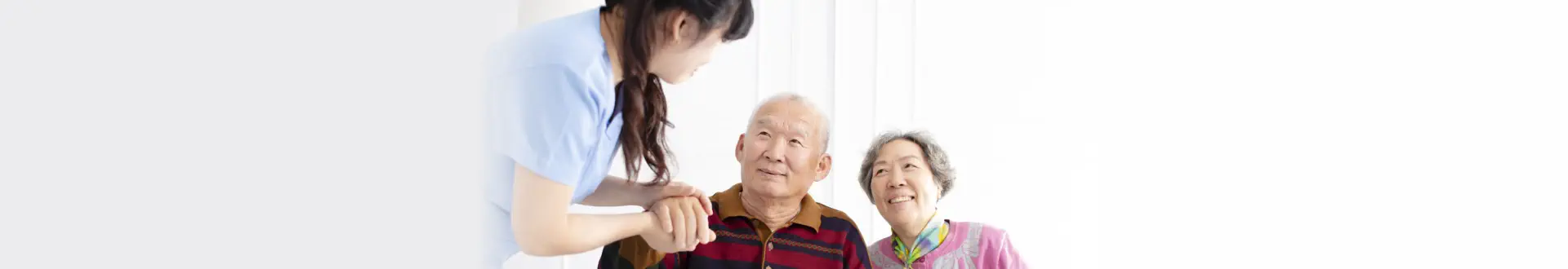 Caregiver helping elderly couple